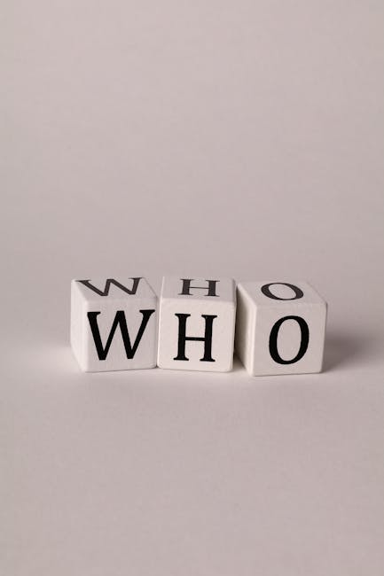 Close-up of letter cubes spelling 'WHO' on a minimal background.